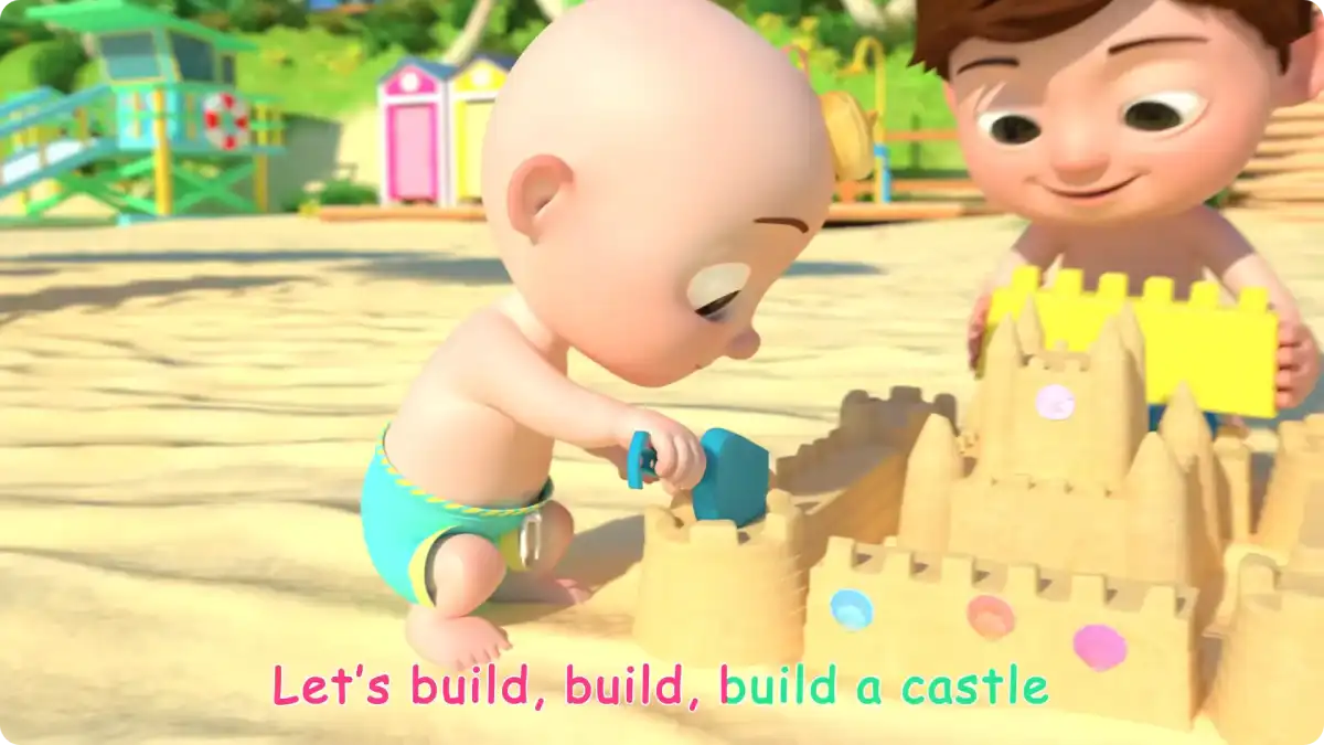 A still from the CoComelon's Beach song; JJ building a sand castle