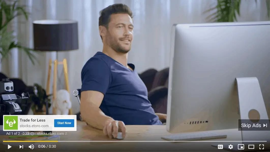 A YouTube ad playing with a smiling man using a mouse to navigate on desktop monitor.